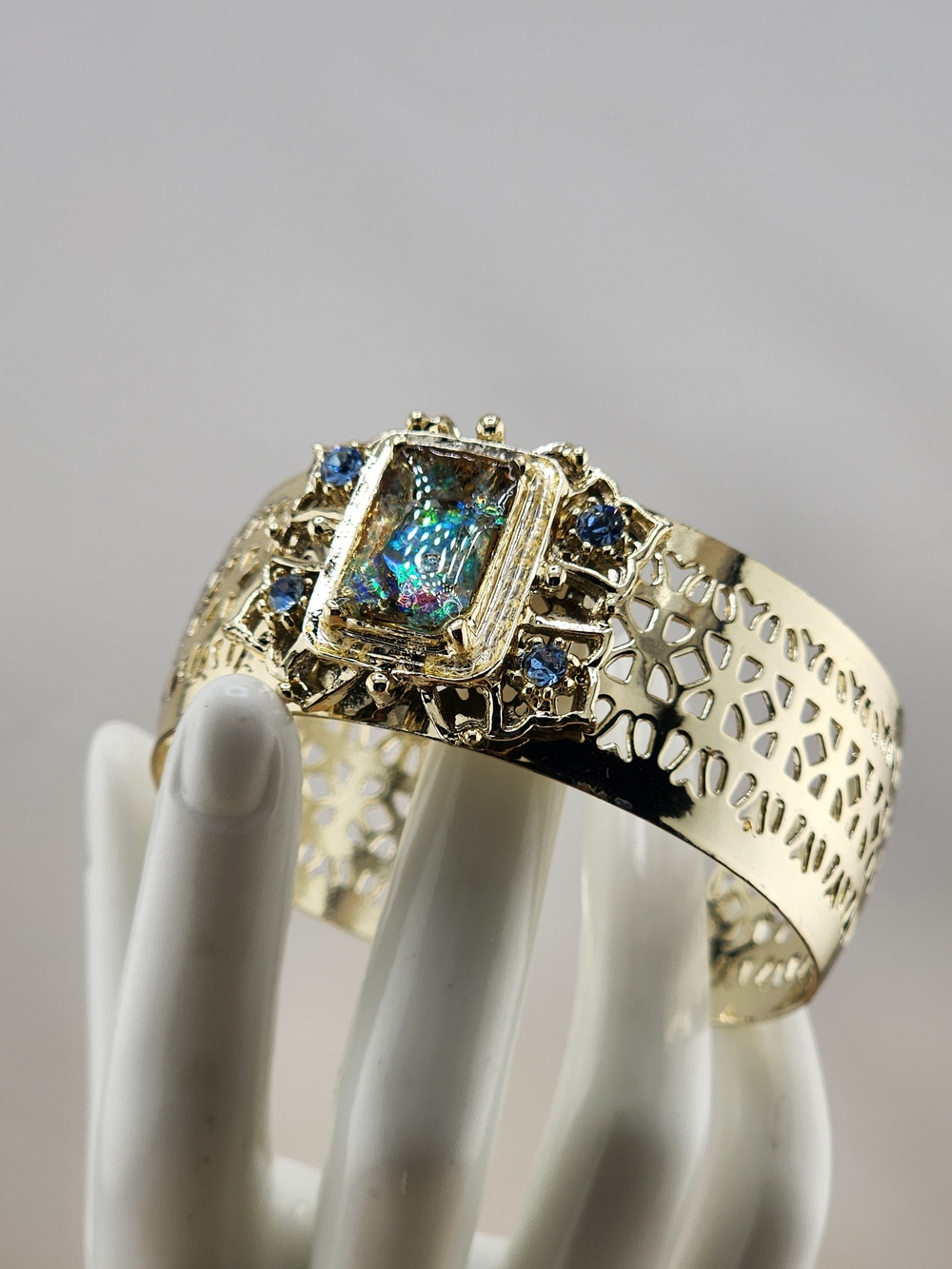 Gold Tone Cuff Bracelet with Multicolor Center Stone and Blue Accent Gems 0543